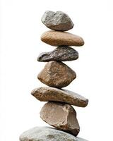 A stack of seven rocks balanced on top of each other against a white background studio shot photo