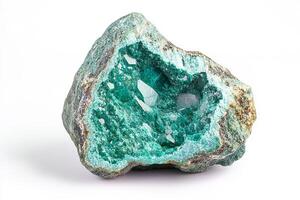 A close up shot of a geode with green and white crystals on a white background surface photo