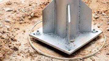 The base of the steel column is fixed with screws on the cement base. The cement is casted with plastic cans as the foundation of the pot. photo
