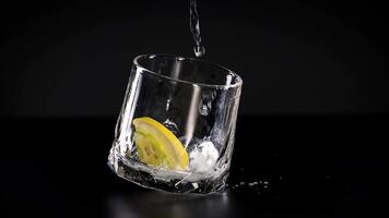 Soda poured into glass with lemon and ice video