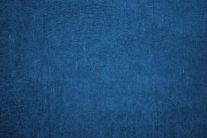 Deep blue textured background. Embossed wall with blue tones photo