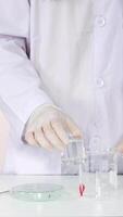 Scientist conducts experiment with lab equipment video