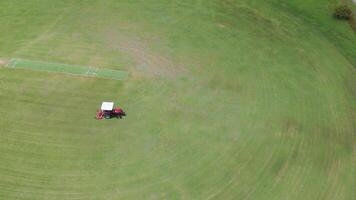 Tractor mowing a large sports field efficiently video
