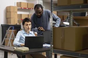 Diverse employees team work in shipping area at the warehouse, small business staff handling inventory and product shipment for a local distribution hub. Accurate order processing. photo