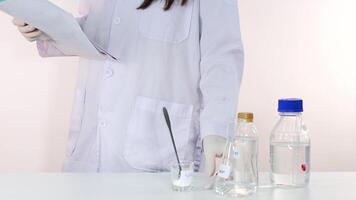 Scientist setting up materials for a lab experiment video