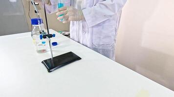 Scientist conducts NaOH chemical reaction in a lab setting, using precise instruments and safety gear under controlled lighting video