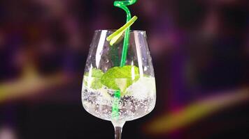 A sparkling mojito cocktail with lime and mint, set against a blurred background, highlighting vibrant colors and refreshing vibes video