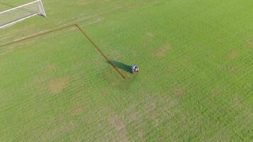 A robot autonomously paints lines on a soccer field, showcasing precision and efficiency in field maintenance video