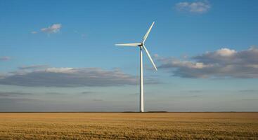 White wind turbine standing in open field for renewable energy visuals, green energy transition concepts, and environmental awareness. Wind turbine in grassy landscape symbolizing clean energy photo