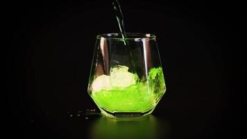 Green liquid poured into glass, creating fizz video