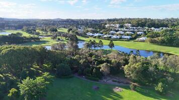 Aerial footage of a lush golf course and resort in Gold Coast, Australia, showcasing vibrant greenery and serene water features video