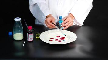 A scientist demonstrates a vibrant color reaction in milk using various liquids, showcasing a captivating chemical experiment video