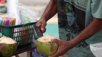 Skilled vendor swiftly opening a coconut. video