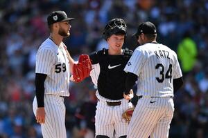 Chicago White Sox starting pitcher Sean Burke (59) completes a mound visit with catcher Kyle Teel (8) and pitching coach Ethan Katz (34) during the first inning against the Cleveland Guardians at Rate Field. editorial_image