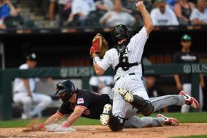 Cleveland Guardians catcher Austin Hedges (27) slides into home plate to score next to Chicago White Sox catcher Kyle Teel (8) during the seventh inning at Rate Field. editorial_image