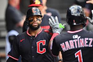 Cleveland Guardians first baseman Carlos Santana (41) celebrates in the dugout with teammates after scoring during the fourth inning against the Chicago White Sox at Rate Field. editorial_image