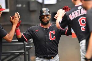 Cleveland Guardians first baseman Carlos Santana (41) celebrates in the dugout with teammates after scoring during the fourth inning against the Chicago White Sox at Rate Field. editorial_image