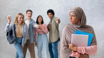 Students interacting with a girl in hijab photo