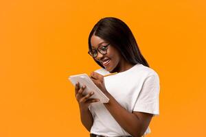 Woman with notebook on orange background photo