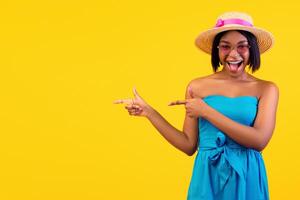Lovely African American woman shouting WOW in excitement, pointing aside at free space on orange studio background, banner design. Pretty black lady offering unbelievable summer sale or discount photo