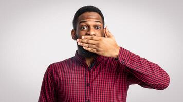 Surprised man covering mouth photo