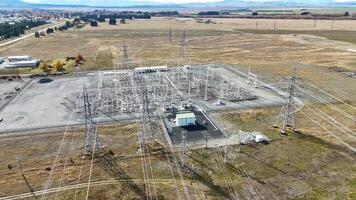 Drone footage captures a high-voltage power substation amidst autumn landscapes at Lake Tekapo, showcasing infrastructure and transmission lines video