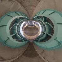 A view of a circular structure with a blue sky photo