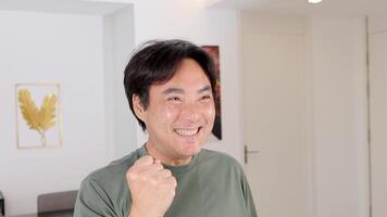 A man expresses excitement and happiness in a well-lit room, showcasing a positive and uplifting moment video