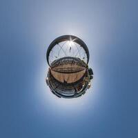 A small planet with a large building in the middle photo