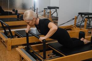 Pilates session focusing on upper body strength and core stability at a fitness studio during morning hours photo