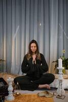 Meditation practice at home during evening with candles, plants, and calming atmosphere creating a peaceful environment photo