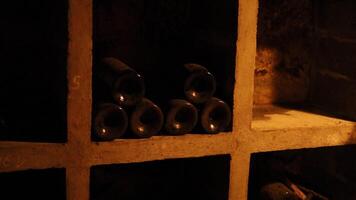 Bottles aging in a dimly lit cellar video
