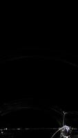 A soap bubble reflects vibrant colors in a dark setting, showcasing dynamic light patterns over 9 seconds video