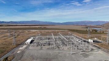 Drone footage captures an expansive electrical substation under clear skies at Lake Tekapo, showcasing infrastructure amidst natural landscapes video