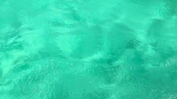 Vibrant turquoise ocean waves gently ripple in Chalong Bay, Phuket, creating a serene and calming visual experience video