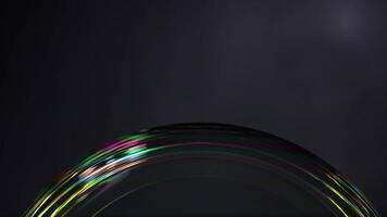 A soap bubble displays vibrant color reflections against a dark background, showcasing light interaction and surface tension video
