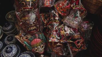 Assorted masks and ceramics displayed on table video