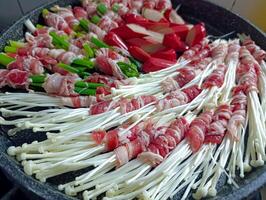 Cooking Meat Rolls with Mushrooms and Vegetables in a Pan photo