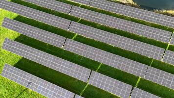 Drone footage captures solar panels in Cromwell, New Zealand, highlighting renewable energy. Bright lighting and green surroundings enhance the scene video