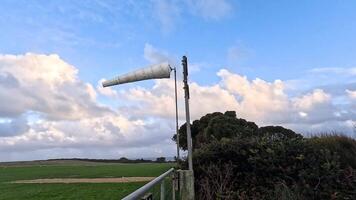 Windsock blowing in the wind, scenic landscape video
