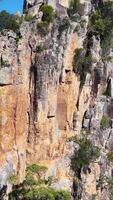 Panoramic view of rugged rock formations and lush greenery under clear blue skies in Nimbin, NSW video