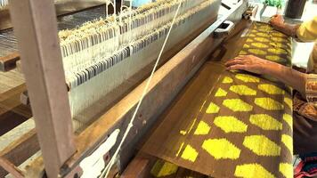 Artisan weaving intricate Thai silk patterns video