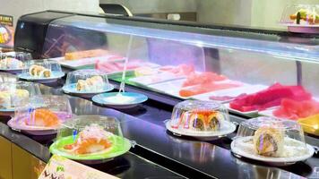 Sushi plates moving on a conveyor belt video