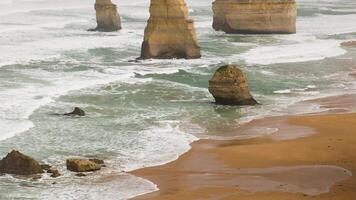 Waves hitting rock formations on a beach video