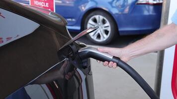 Sequence showing electric vehicle being charged video