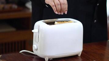 Person toasting bread in a toaster video
