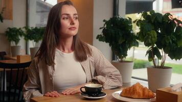 Caucasian woman visitor in cafe checking time with wristwatch late business meeting looking in window waiting date lonely girl female at cafeteria table worry wait impatient lateness upset frustrated video