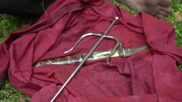 Sword and Hook on Red Cloth in Nature video