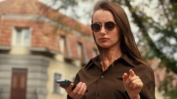 Confused Caucasian woman female girl lost in new in city using mobile phone map internet application searching road direction gps app looking around businesswoman with smartphone navigation outdoors video