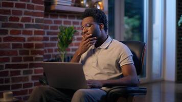 Thoughtful businessman African American guy thinking business man searching idea in evening office consider decision male trader employee think project plan online late working laptop in dark night video
